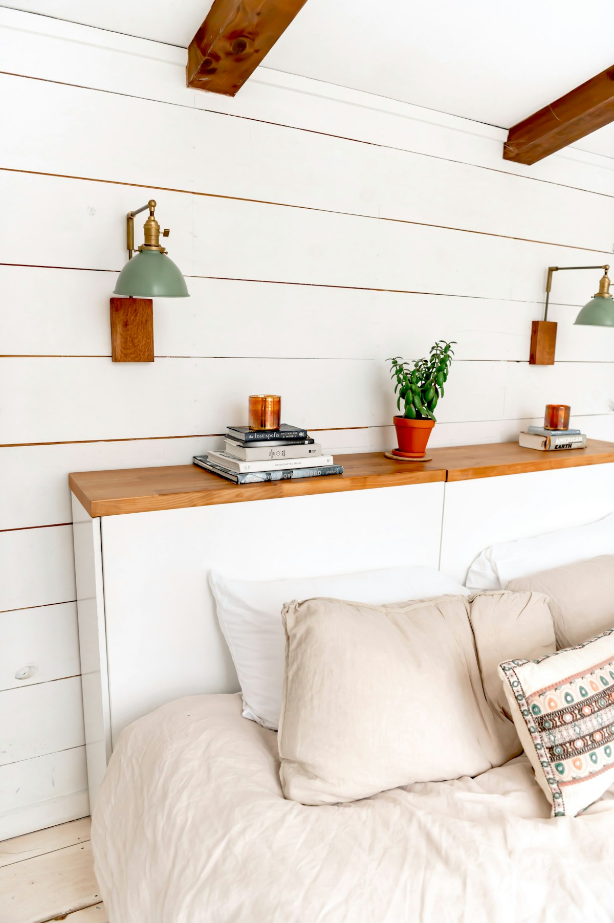 Cozy bedroom furniture with headboard shelves and lamps