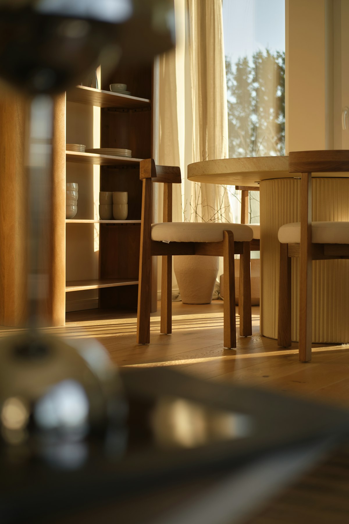 Sunlit dining room furniture with wooden chairs